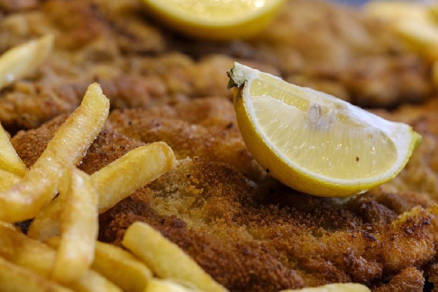 Schnitzel with fries and lemon as usual with Wienerschnitzel